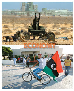 - 반카다피 시위대 소속 전투원들이 8일 리비아 중부 해안 도시 라스라누프의 한 정유시설 앞에 배치된 대공포 옆에서 절을 하며 기도하고 있다(위). 리비아 한 소년이 자전거에 리비아국기를 단 채 왕궁 앞을 지나고 있다.