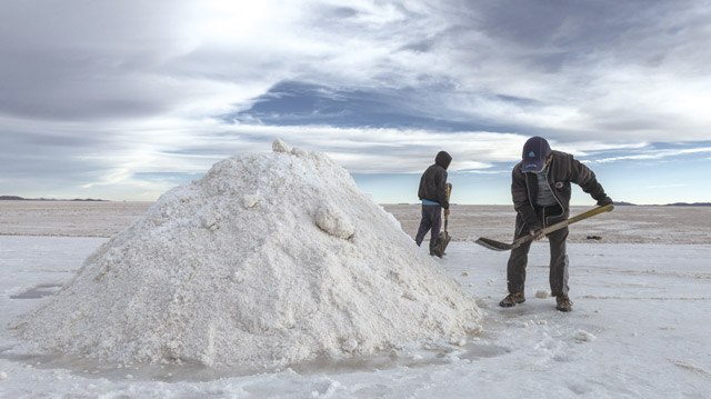 볼리비아의 우유니 염호(Salar de Uyuni)에서 인부들이 리튬을 얻기 위해 소금을 채취하고 있다. <사진 : 블룸버그>