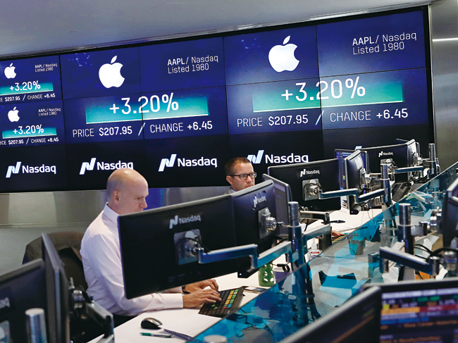 미국 뉴욕 타임스퀘어에 있는 나스닥 마켓사이트에서 애널리스트들이 나스닥 상장사인 애플의 주가 화면을 보고 있다. 나스닥은 미국 뉴욕증권거래소(NYSE)와 함께 양대 거래소로 불린다. 사진 블룸버그
